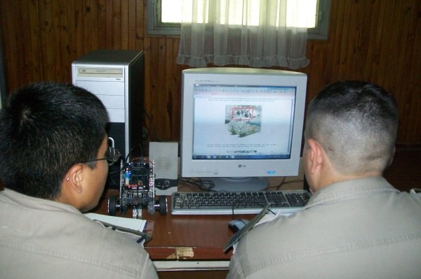 In May, cadets drive a controller board during an educational robotics initiative.
