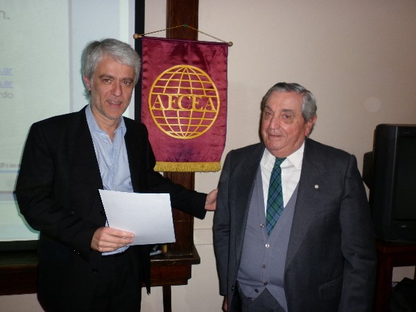 Ricardo Senz (l), Ph.D., receives a certificate of recognition from Adm. Nigoul in September.