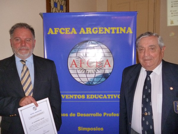 Rear Adm. Emilio Nigoul, ARA (Ret.) (r), chapter president, presents a certificate of appreciation in December to guest speaker Alejandro Prince, Ph.D., Prince Consulting director.