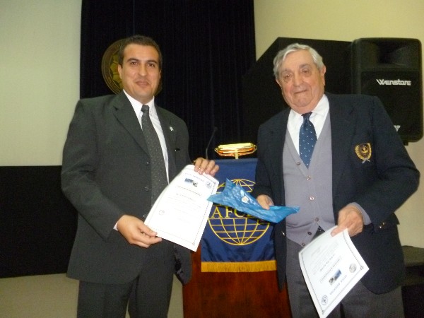 In May, Rear Adm. Nigoul (r) presents a certificate of recognition to Claudio Baielli.
