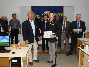 At the cyber defense competition in September, Sanchez Barbeito presents a certificate to Cadet Jorge Ralo, Army Lyceum Espejo.