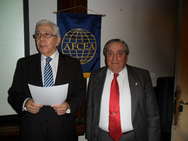 Uzal (l) receives a certificate of recognition from Rear Adm. Emilio Nigoul, ARA (Ret.), chapter president, following his speech at the June conference.