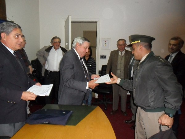 In April, Adm. Nigoul presents a certificate to an attendee of the lecture on physics.