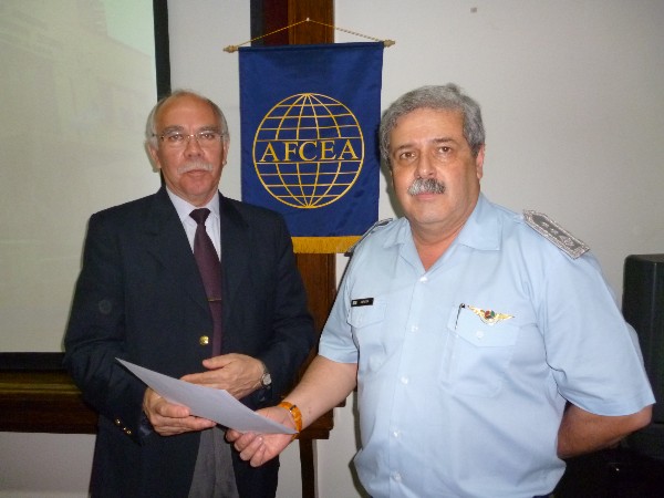 Maj. Gen. Guillermo Saravia, FAA (r), radar sensors director, receives a certificate from Col. Gonzalez recognizing his participating in the September conference.
