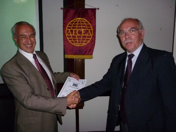 Col. Oscar Gonzalez, FAA (Ret.) (r), chapter vice president, presents a certificate of recognition to Favotto in November.