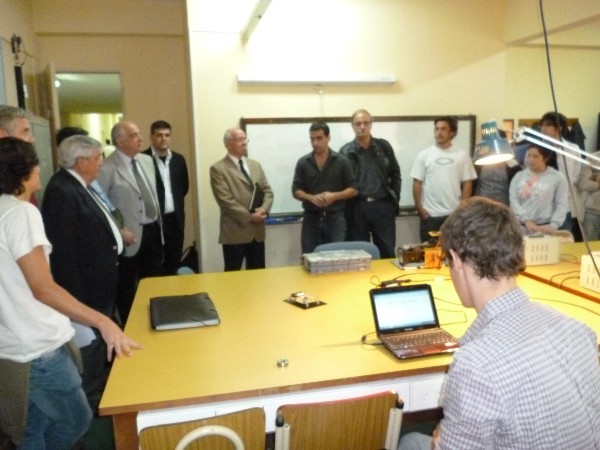 Members of the chapter board gather in March for a demonstration of the robotics lab at the Army University.