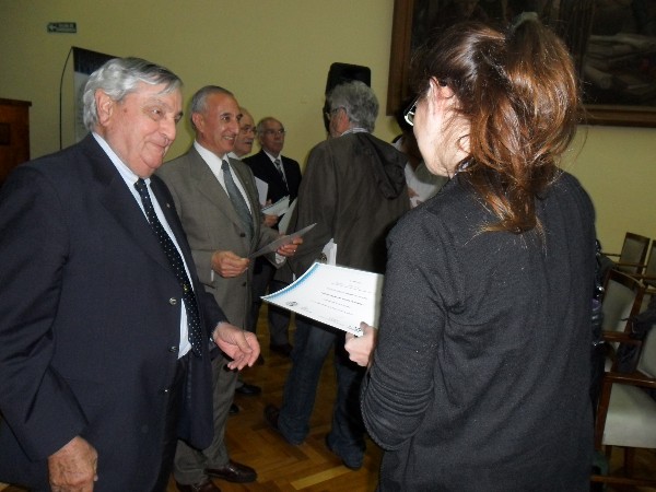 Adm. Nigoul (l) presents a certificate to an attendee of the November conference.