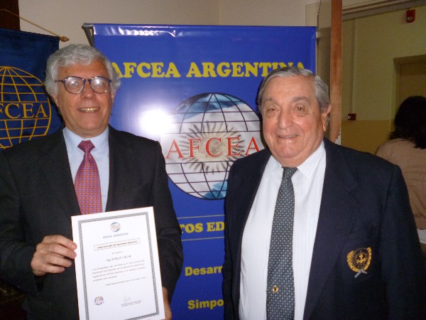 Adm. Nigoul (r) delivers a certificate to the lecturer Jorge Crom in October.