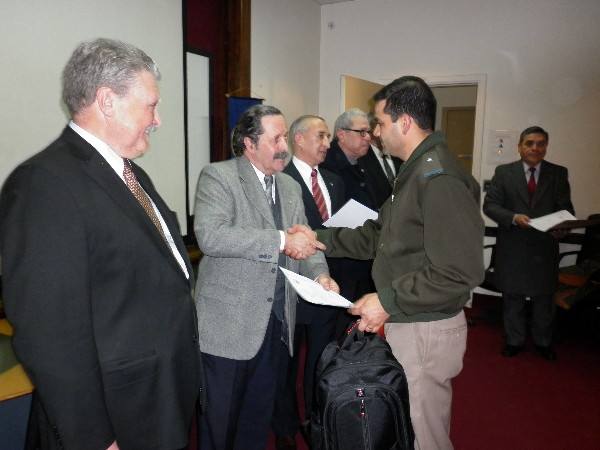 Gen. Dimeglio (c) and Martino (l) present a certificate to an attendee of the August conference titled “Public Safety and Biometrics Applications.”