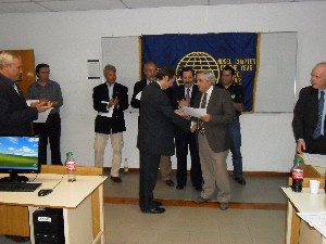 Adm. Nigoul (r) presents a certificate to Mariano Pancaldi in September.