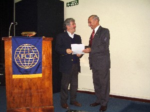 In June, Bolognini (l) receives a certificate of appreciation from Luis Favotto, a member of the chapter's board.