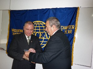 Juan C. Fondevila Sancet (r), regional vice president, presents a medal to Olarte in December.