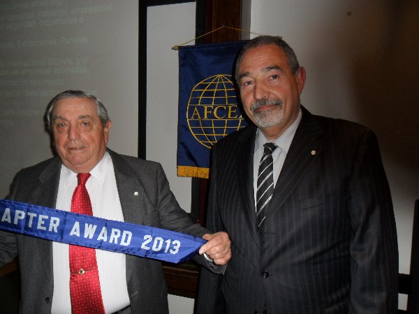 Adm. Nigoul (l) receives the Model Chapter of the Year Award from Juan Carlos Fondevila Sancet, regional vice president for South America, in June.