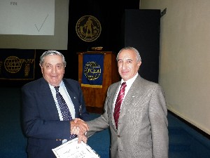 In November, Rear Adm. Emilio Nigoul, ARA (Ret.) (l), chapter president, presents a certificate of appreciation to Luis Alberto Favotto, chapter board member and coordinator of the symposium.