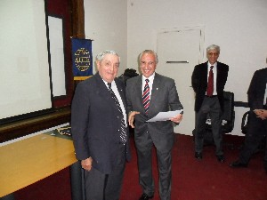 Adm. Nigoul (l) presents a certificate of appreciation to Favotto for his coordination of the October event.