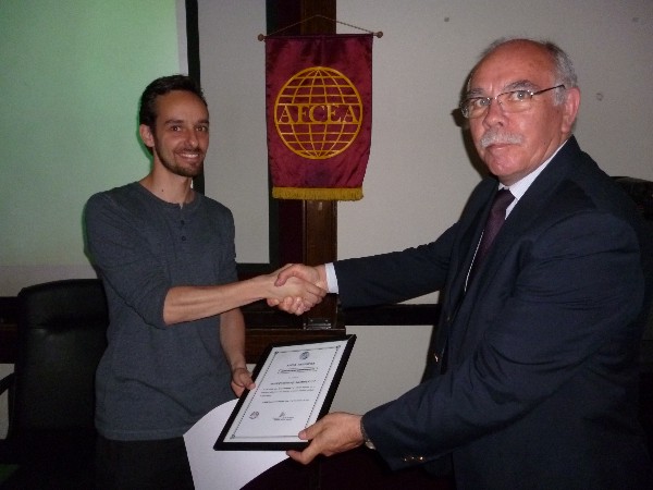 At the November conference, Monticeli (l) receives a Distinguished Membership diploma from Col. Gonzalez.