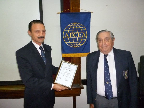 In September, Col. Elejandro Echazu, EA, former Army University director, receives a certificate from Adm. Nigoul recognizing the university's continued collaboration with the chapter.