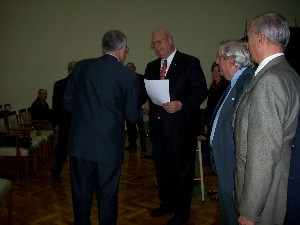 At the April conference, Kent R. Schneider (r), president and chief executive officer of AFCEA International, presents a certificate of appreciation to Patricio Marco, member, chapter advisory council, for his coordination of the conference.