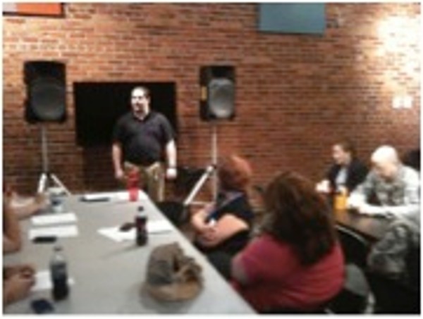 Robert Bills, Ohms Systems Incorporated, speaks to government and industry information technology professionals while demonstrating social engineering tactics at the chapter's Continuing Education Lunch and Learn in August.