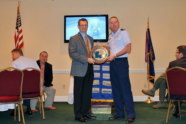 Col. Frank Simcox, USAF, chapter president, presents Brian Vandegrift, executive vice president of Venyu, with a chapter plaque in appreciation for his speech to the March luncheon crowd.