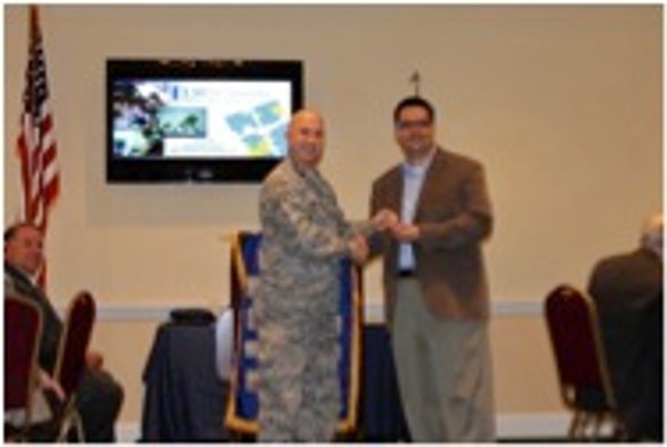 Lt. Col. Curtis Juell, USAF, chapter president, thanks John Miralles of Louisiana State University Shreveport for his presentation to the chapter at its August luncheon.