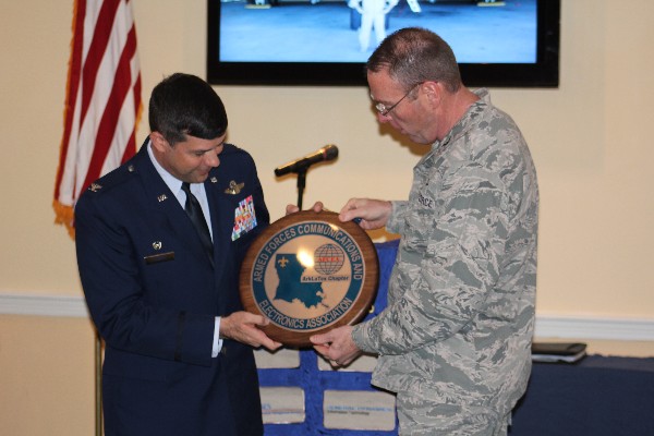 Col. Frank Simcox, USAF (r), chapter president, presents Col. Gebara with an honorary chapter “coin” in appreciation for his speech to the chapter in November.