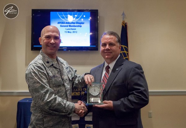 In May, Col. Juell (l) presents Kevin Smith, chapter vice president, with a chapter award recognizing his AFCEA Leadership Award presented at the Joint Warfighting Conference 2012.