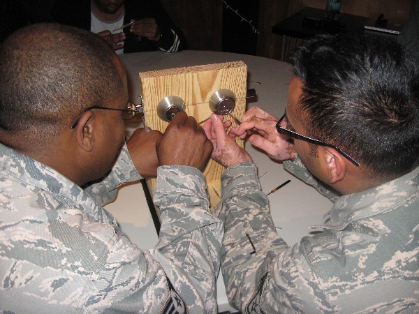 Participants take part in hands-on lock picking training during a December lunch and learn event.