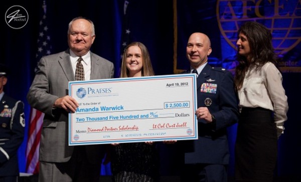 Lt. Col. Curtis Juell, USAF (2nd from r), chapter president; Frank Auer (l), chief executive officer of Praeses; and Michelle Glick (r) present Amanda Warwick with a $2,500 scholarship at the chapter's annual April banquet.