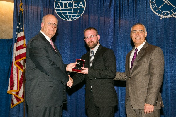 At the AFCEA West conference in January, Scott Vines (c) accepts his Distinguished Young AFCEAN Award from Kent R. Schneider (l), president and chief executive officer of AFCEA International, and Al Grasso, chairman of AFCEA's board. Vines also accepted the Outstanding Young AFCEAN Program Award, large chapter category, on behalf of the chapter.