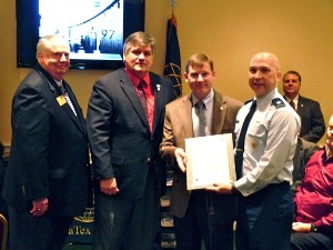 Gwaltney (l), Kelley (2nd from l) and Col. Juell (r) present Andy Thomson with a lifetime membership certificate and lapel pin and to recognize him as a Founding Father of the chapter in January.