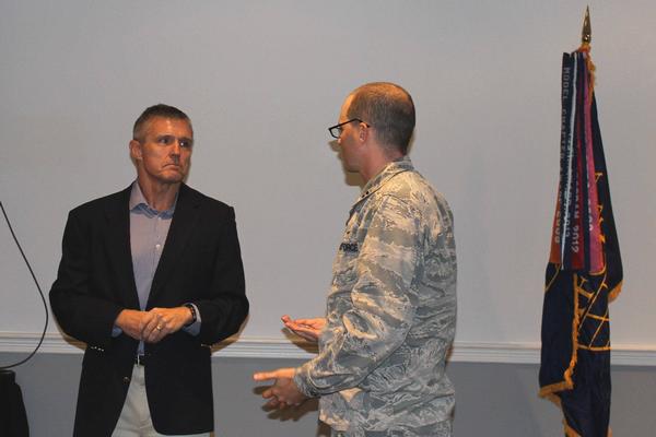 Capt. James McDavitt, USAF, chapter vice president, presents Gale a chapter coin as a token of appreciation for speaking at the October luncheon.