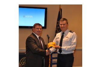 Col. Charles Allen, USAF (r), chapter president, presents a token of appreciation to guest speaker Ron Isom, vice president of operations, Tapestry Solutions, a Boeing Company.