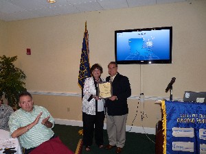 In July, Sandra Braddock, president of Jean Simpson Personnel Services, accepts an AFCEA International Corporate Sponsor Certificate from Kevin Smith, chapter vice president.