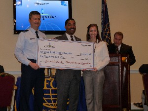 At the September luncheon, Col. Allen (l) receives a check from Chesapeake Energy Corporation representatives Paul Pratt (c), senior manager of public affairs, and Natalie Cunningham, coordinator for administration. The company is the chapter's newest Diamond Sponsor and largest Founding Father-level contributor to the chapter's Friends of AFCEA campaign.