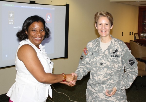 Chapter President Michelle Brown (l) thanks Col. Jan Apo, USA, defense coordinating officer, Federal Emergency Management Agency Region IV, for her outstanding presentation and vehicle tour in May.