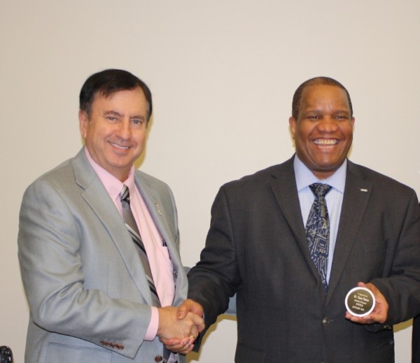 David Landry, chapter president, gives a speaker appreciation coin to Dr. Vince Patton, director of the AFCEA Educational Foundation, at the January luncheon.