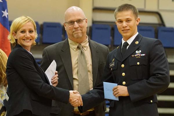 Chapter board members Patricia Giesler and Paul Wertz present Cadet Staff Sgt. Casey Johnson, Corps of Cadets, his medal, ribbon and cash stipend as AFCEA Outstanding Cadet at the University of North Georgia Corps of Cadets Military Awards Night in March. 