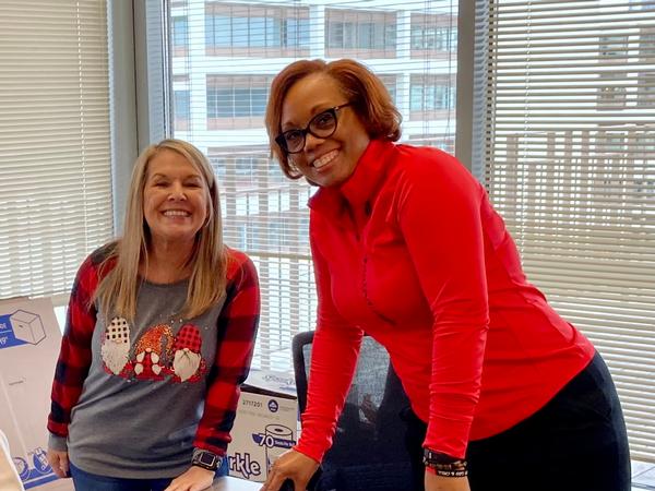 At the December event, Sandra Daniels (l) and D'Joane McCorkle take turns finishing off the bags as they are boxed up and ready to go!