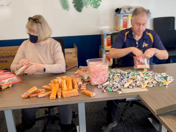 Pat Harrington and David Landry carefully stuff the plastic bags at the December event.