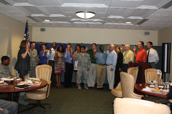 Col. Patricia Harrington, USAF (Ret.) (l), regional vice president, installs the chapter's 2012-2013 officers in July.