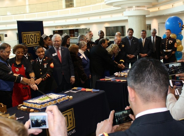 Guests watch as Ambassador Young and Austin cut recognition cake at the USO facility in February.