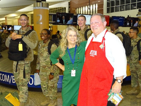 As soldiers look on, Mary Lou Austin, CEO and president of USO of Georgia, thanks project coordinator Terry Whitlock for the chapter's many years of support during December Holiday Block Leave.