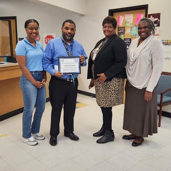 Javen McCaster, Bayvale Elementary, receives a STEAM grant while standing with Justine McDonald (l), Vanessa Darling, Bayvale principal (c), and Melissa Johnson (r).