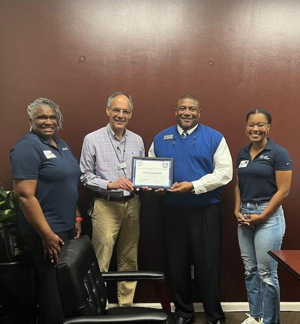 A Lakeside High School teacher receives a chapter STEAM grant. Pictured (l-r) are Johnson; David Kassner, grant recipient; Rodney Tyson, principal; and McDonald. 