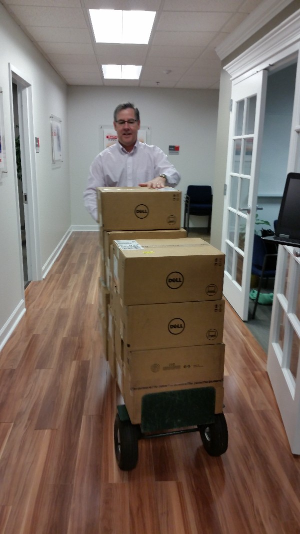 Past Chapter President, Bob Damen, rolls out Dell computers for the presentation to the Central Savannah River Association Boys and Girls Club at the Clubhouse in January. 