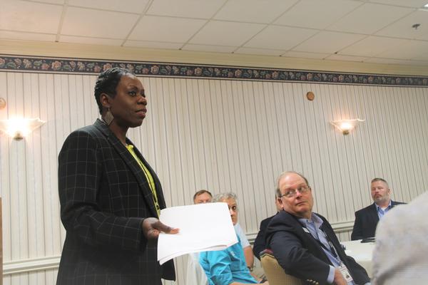 Patty Queen-Harper, director of contracting, Mission and Installation Contracting Command, discusses how the Mission Installation Contracting Command–Fort Gordon can best serve AFCEA members.  Eric Gladman, chapter vice president, looks on at the April meeting. 