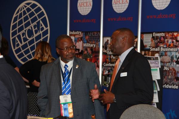 Col. Sly Cotton, USA (Ret.) (r), volunteers at the AFCEA booth and discusses the benefits of membership with Andrew Reese during TechNet Augusta in August.