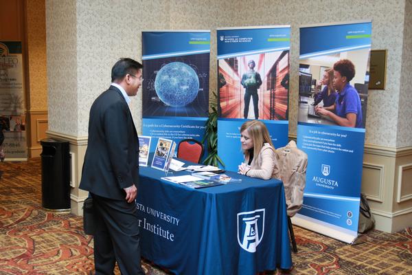 Haley Bourne from Augusta University's Cyber Institute talks about its mission with an attendee during January's CERTS. 