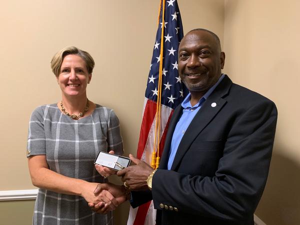 Col. Sly Cotton, USA (Ret.), chapter president, presents McLeish with a small token in appreciation for an outstanding presentation at the October event.